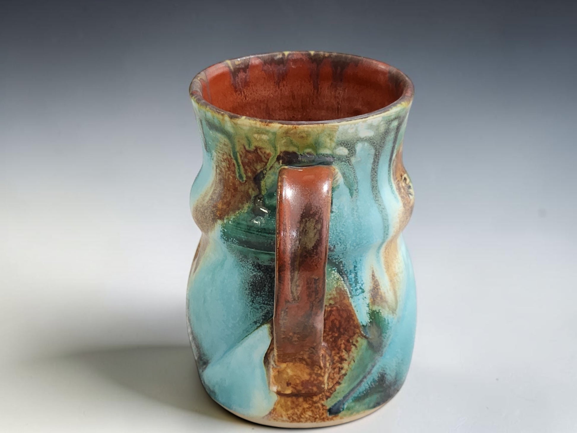 Australian handmade pottery mug with unique Bush Creek glaze variation and hand-pulled handle