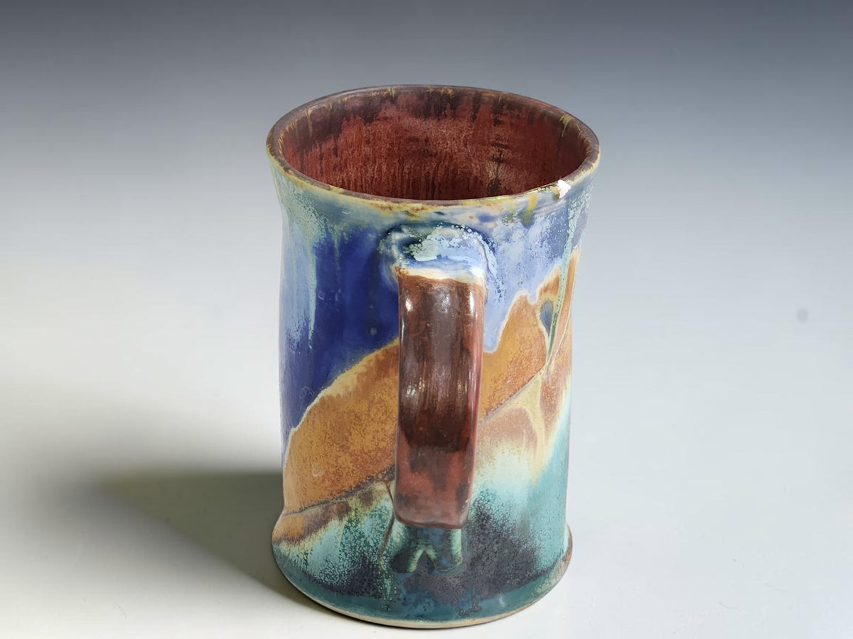 Buxton Pottery 300ml coffee mug measuring 12cm tall and 7.5cm across the base.