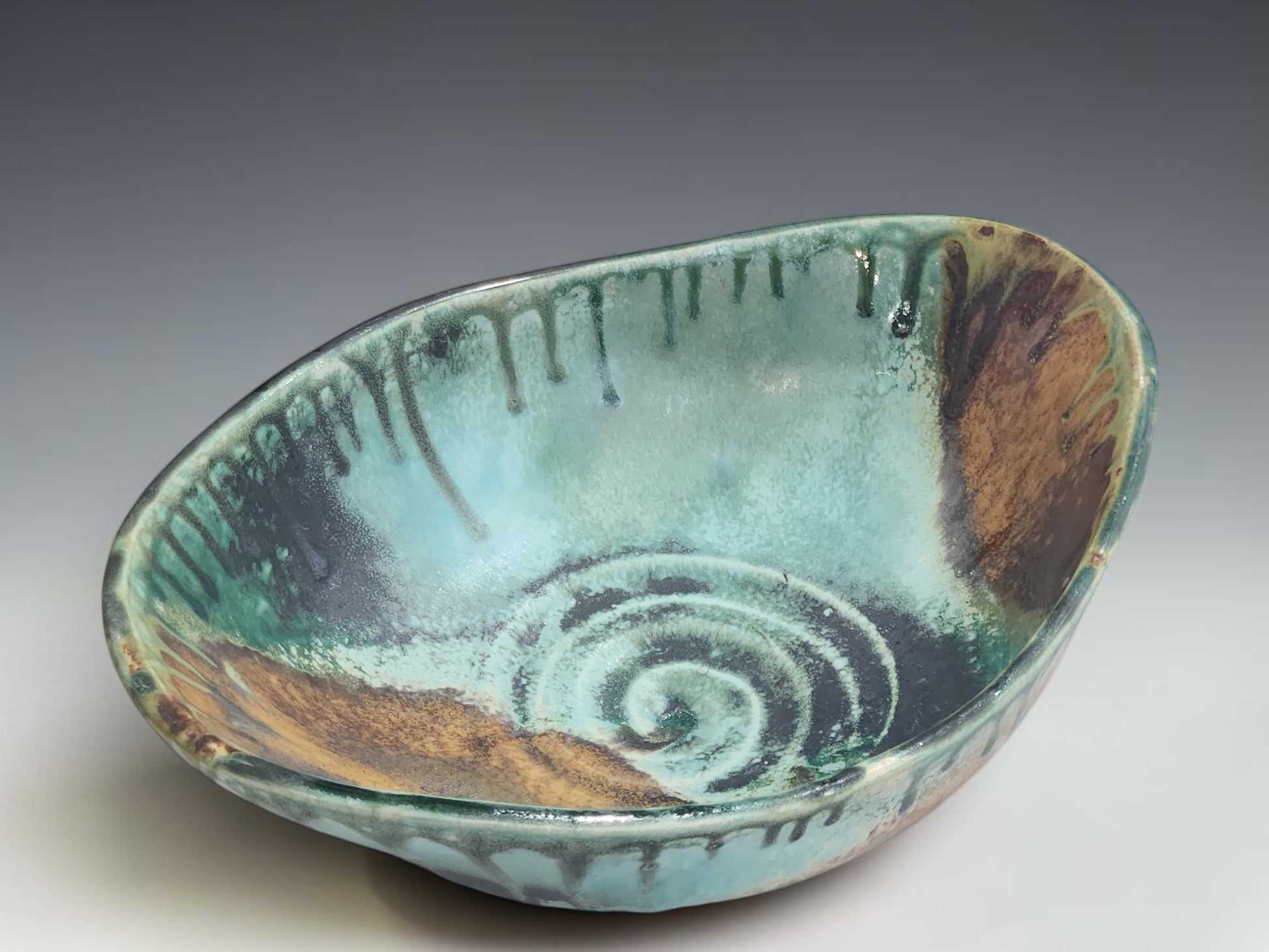 Handmade pottery serving bowl with organic oval shape and sculptural altered form