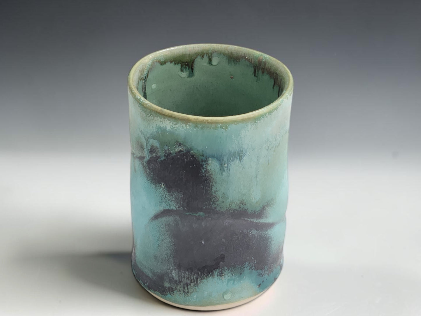 Wheel-thrown pottery cup in green blue glaze, handmade in Melbourne studio