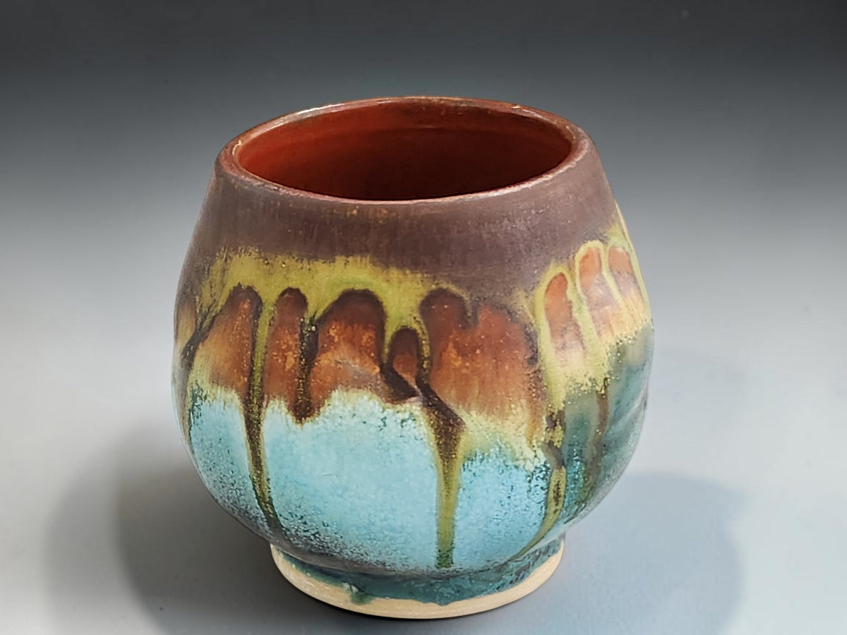 Handleless yunomi cup with earthy rust and green glaze detailing