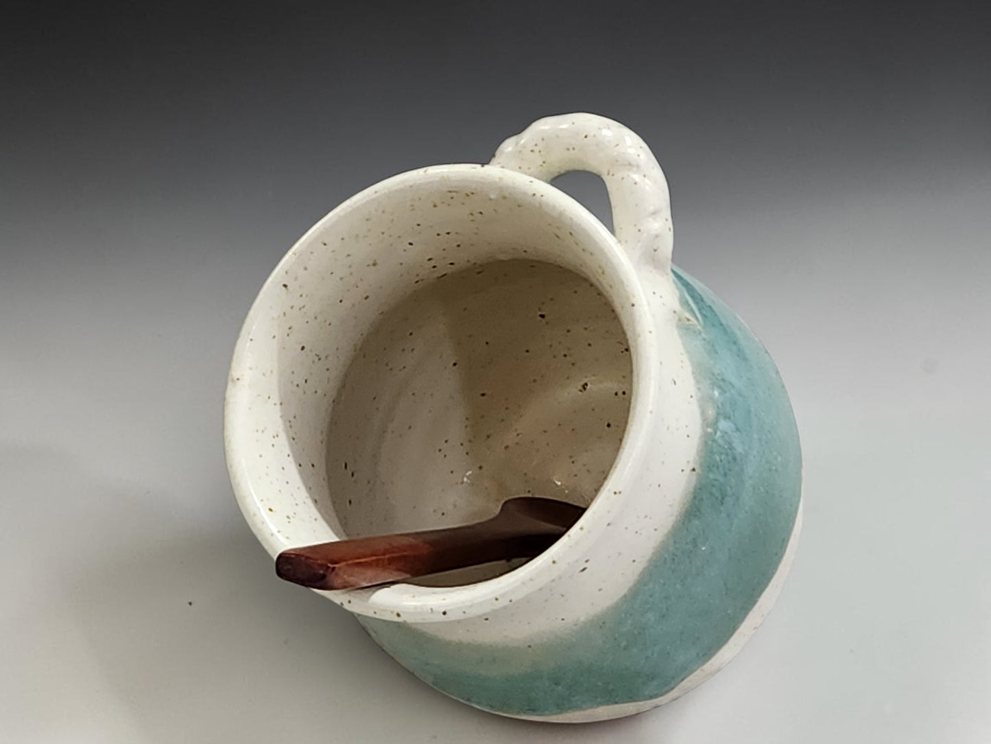 Small handmade pottery salt pig in buttermilk cream and spearmint green glaze