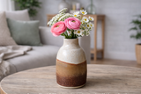 handmade pottery bud vase, 12cm ceramic bottle vase, wheel-thrown ceramics, Melbourne Australia, unique gift, neutral speckled glaze with earthy brown tones, styled with flowers on coffee table in lounge room