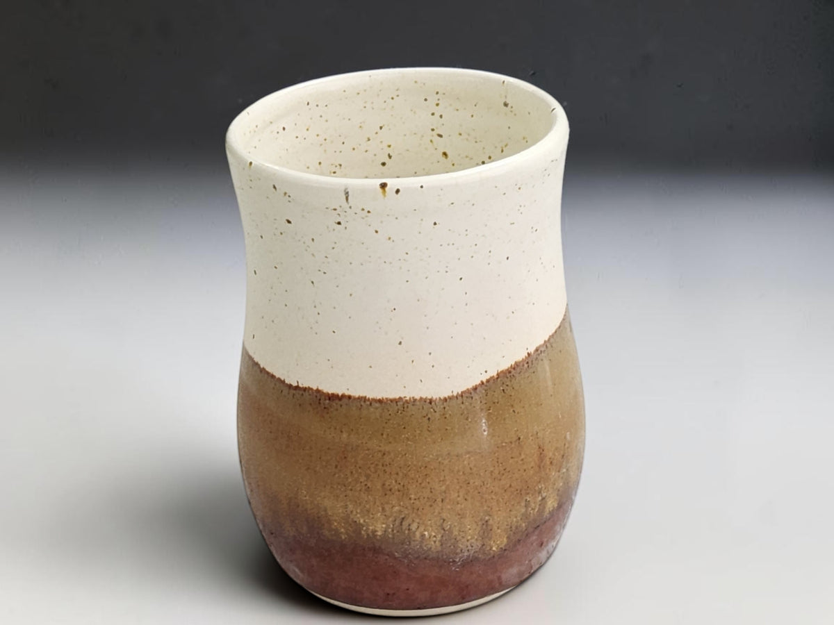 Wheel-thrown ceramic mug measuring 13cm tall with a 9cm belly