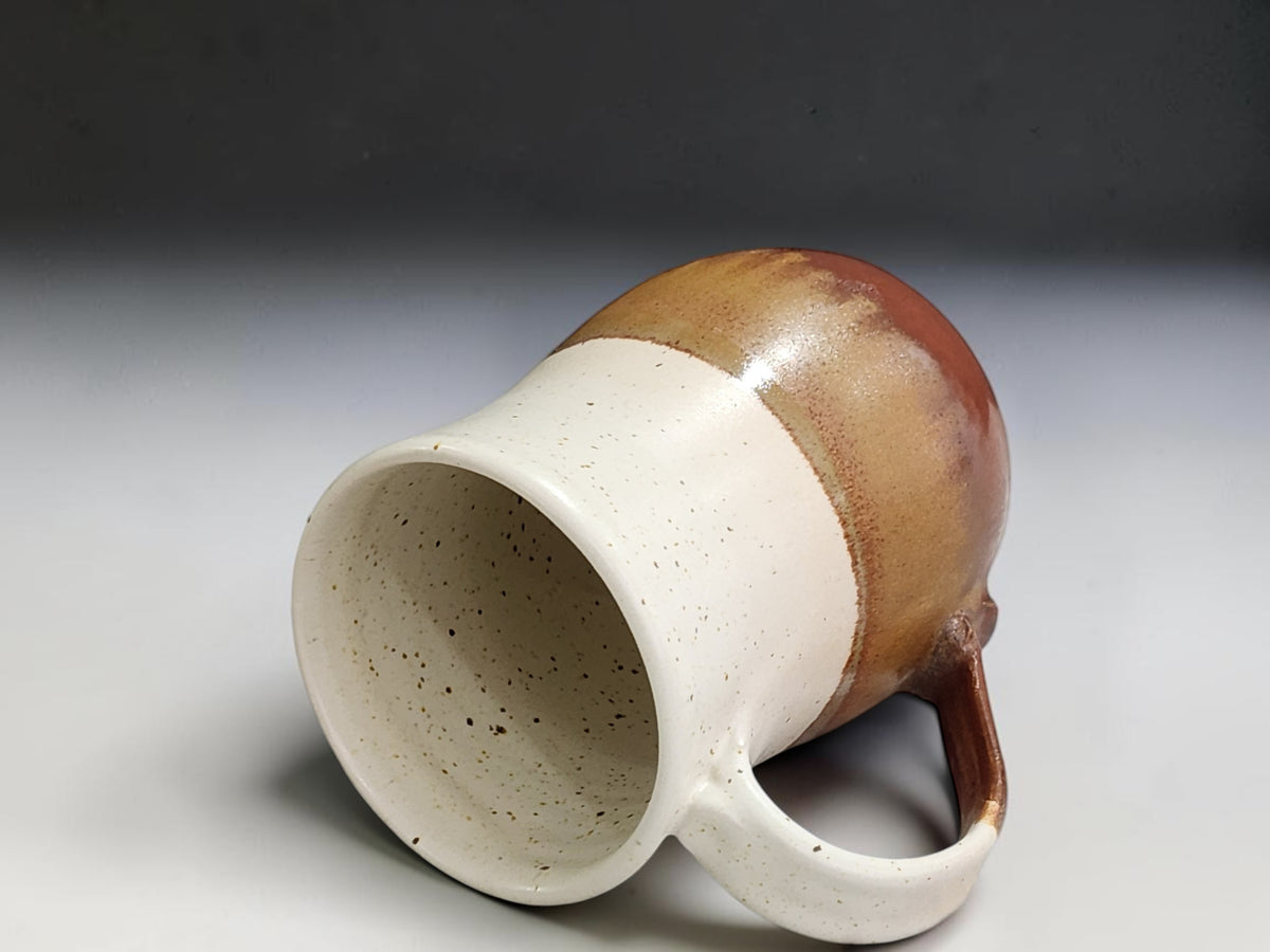 Side view of large stoneware mug showing its slender handmade handle