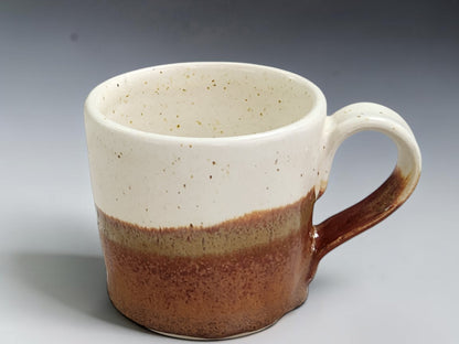 Wheel-thrown espresso cup with earthy red-orange lower glaze
