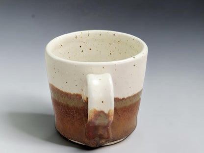 Handmade ceramic espresso cup showing natural glaze variation
