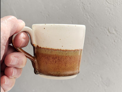 Wheel-thrown espresso cup with earthy red-orange lower glaze