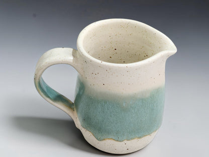 Small wheel-thrown stoneware milk jug with hand-shaped pouring lip