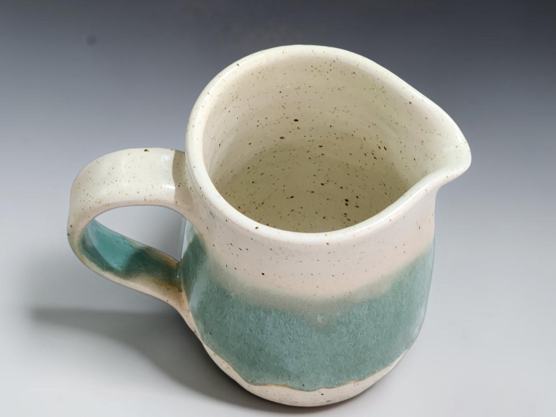 Australian pottery cream jug measuring 10.5cm tall with an 8cm belly