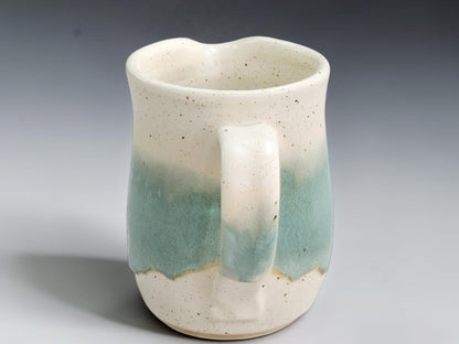 Side view of spearmint pottery jug showing its compact curved handle
