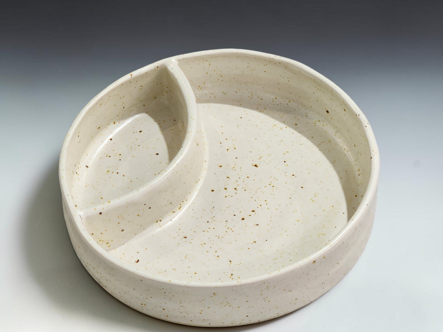 Handmade stoneware divided snack bowl with built-in dip section for casual entertaining