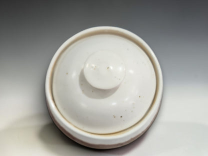  top view  of an Artisan stoneware sugar bowl with fitted lid, glossy cream top and earthy brown base, shown in a clean studio product photograph on a neutral grey gradient sweep.