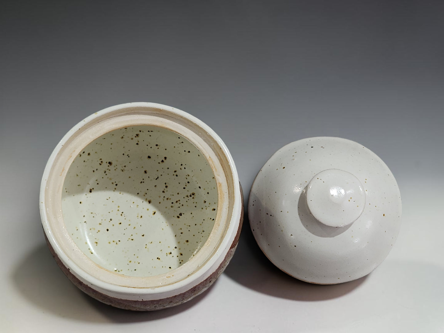 Decorative stoneware sugar bowl with lid, featuring a soft cream glaze and rich brown banding, made by buxton Pottery Melbourne.