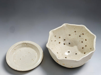 Australian handmade ceramic colander bowl in speckled cream glaze for berries and small fruit