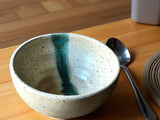 Handmade pottery cereal bowl speckled cream with green slash