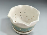 Artisan pottery berry bowl with cream glaze and green drip detail