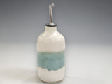 Handmade ceramic oil bottle in cream and soft green glaze