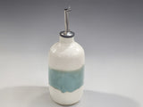 Cream and green pottery oil bottle with stainless steel pour spout