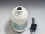 Unique handmade pottery oil bottle with glossy cream and green finish