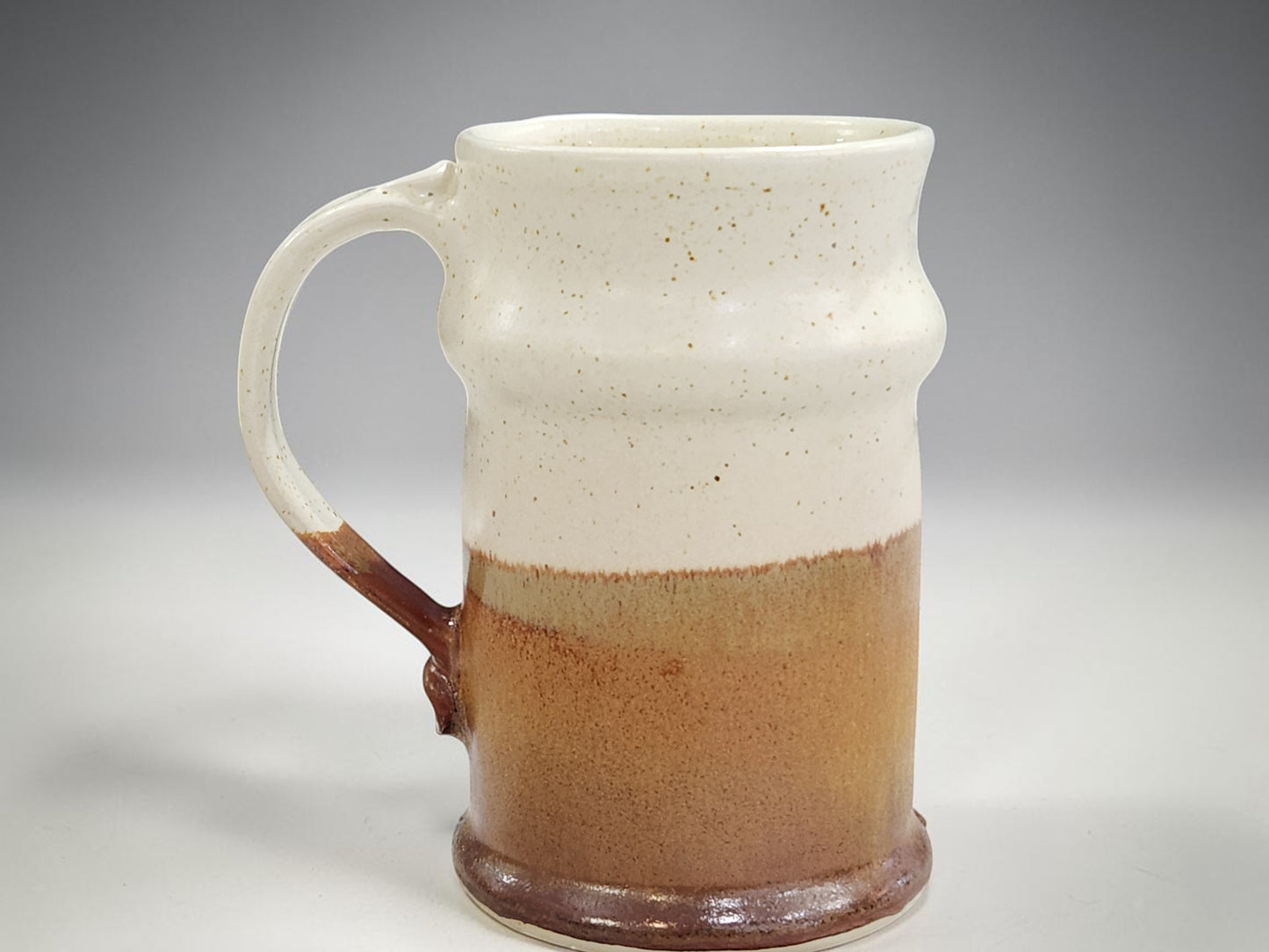 Handmade pottery beer stein in speckled cream and brown glaze