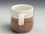 Brown and cream pottery mug with comfortable handle