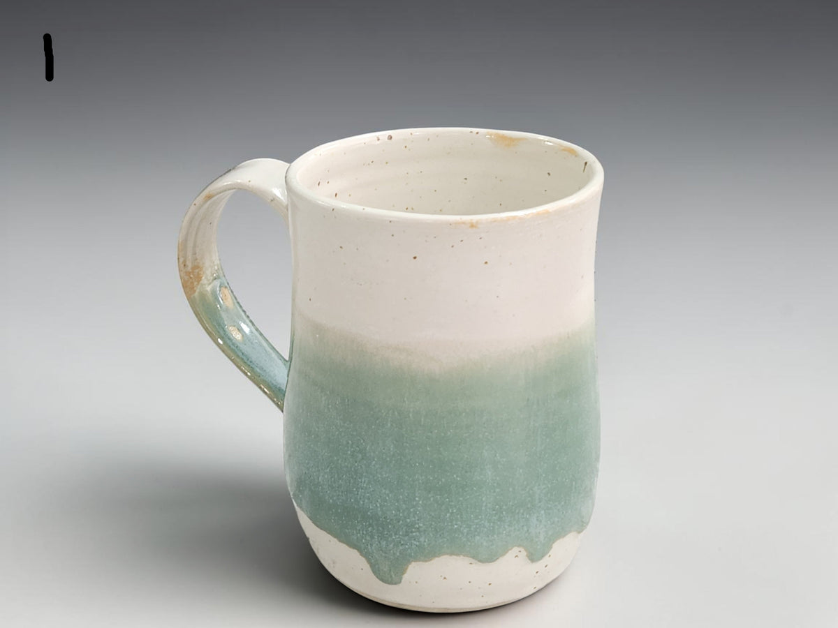 Handmade ceramic mug in cream and soft green glaze