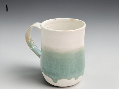 Handmade ceramic mug in cream and soft green glaze