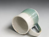 Artisan pottery mug in cream and sage green tones