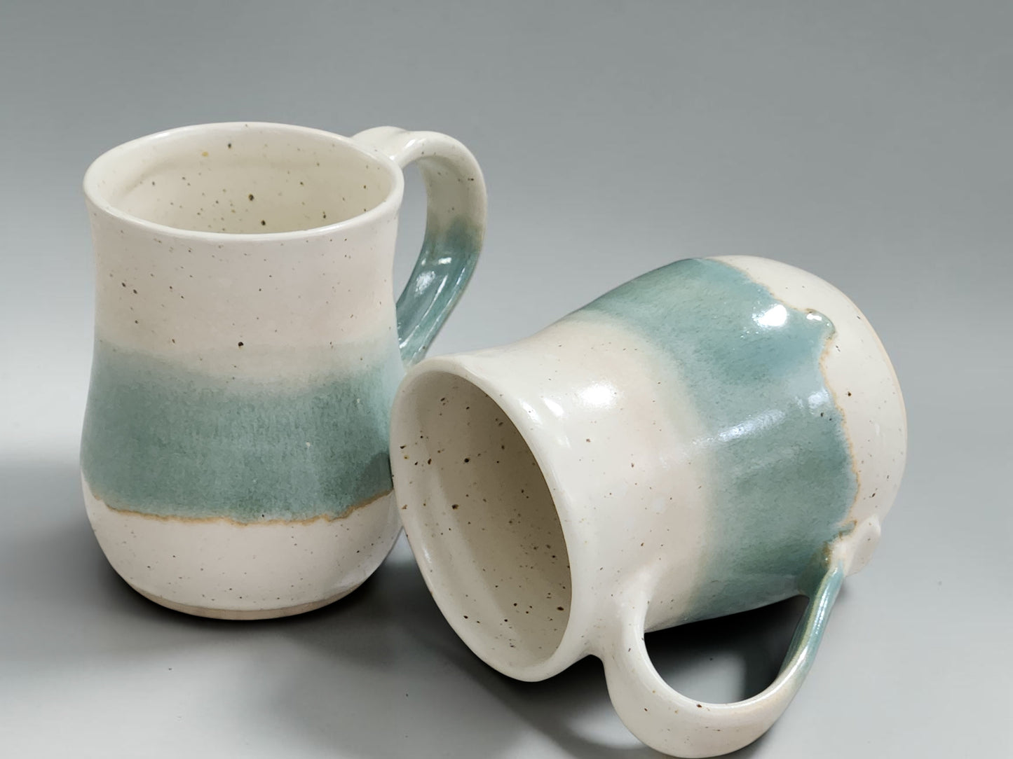 Wheel-thrown pottery mug with comfortable handle and glossy food-safe glaze, handcrafted by Buxton Pottery using traditional ceramic techniques.