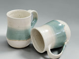 Wheel-thrown pottery mug with comfortable handle and glossy food-safe glaze, handcrafted by Buxton Pottery using traditional ceramic techniques.