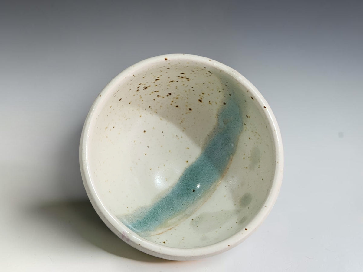 Handcrafted ceramic bowl measuring 8.5cm wide and 5cm tall with rounded sides.