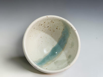 Handcrafted ceramic bowl measuring 8.5cm wide and 5cm tall with rounded sides.