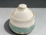Speckled cream and green pottery sugar bowl with matching lid