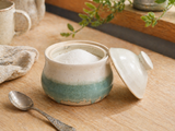Handmade ceramic sugar bowl in a kitchen lifestyle setting with lid beside bowl