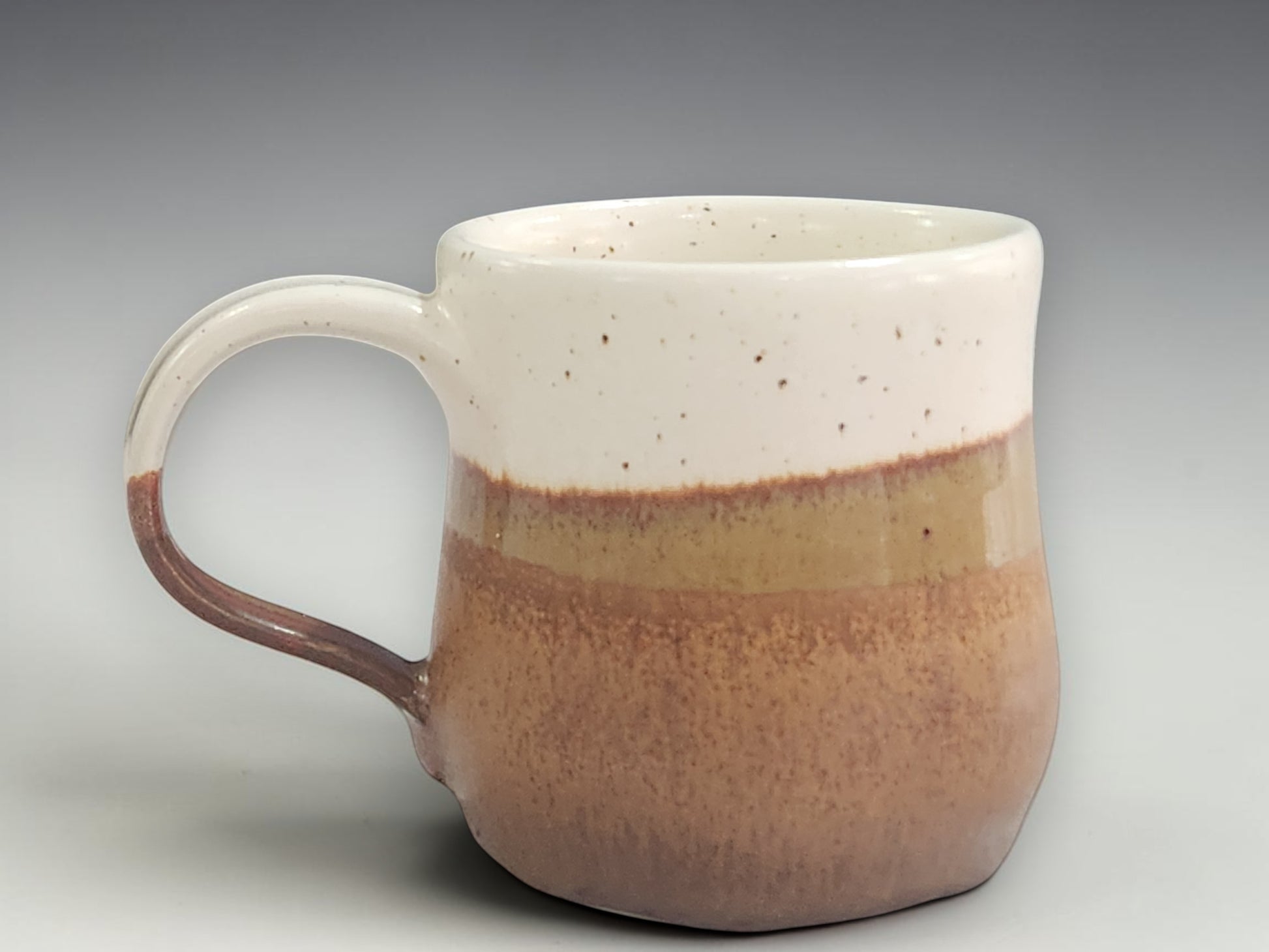Handmade ceramic mug in cream and warm brown glaze