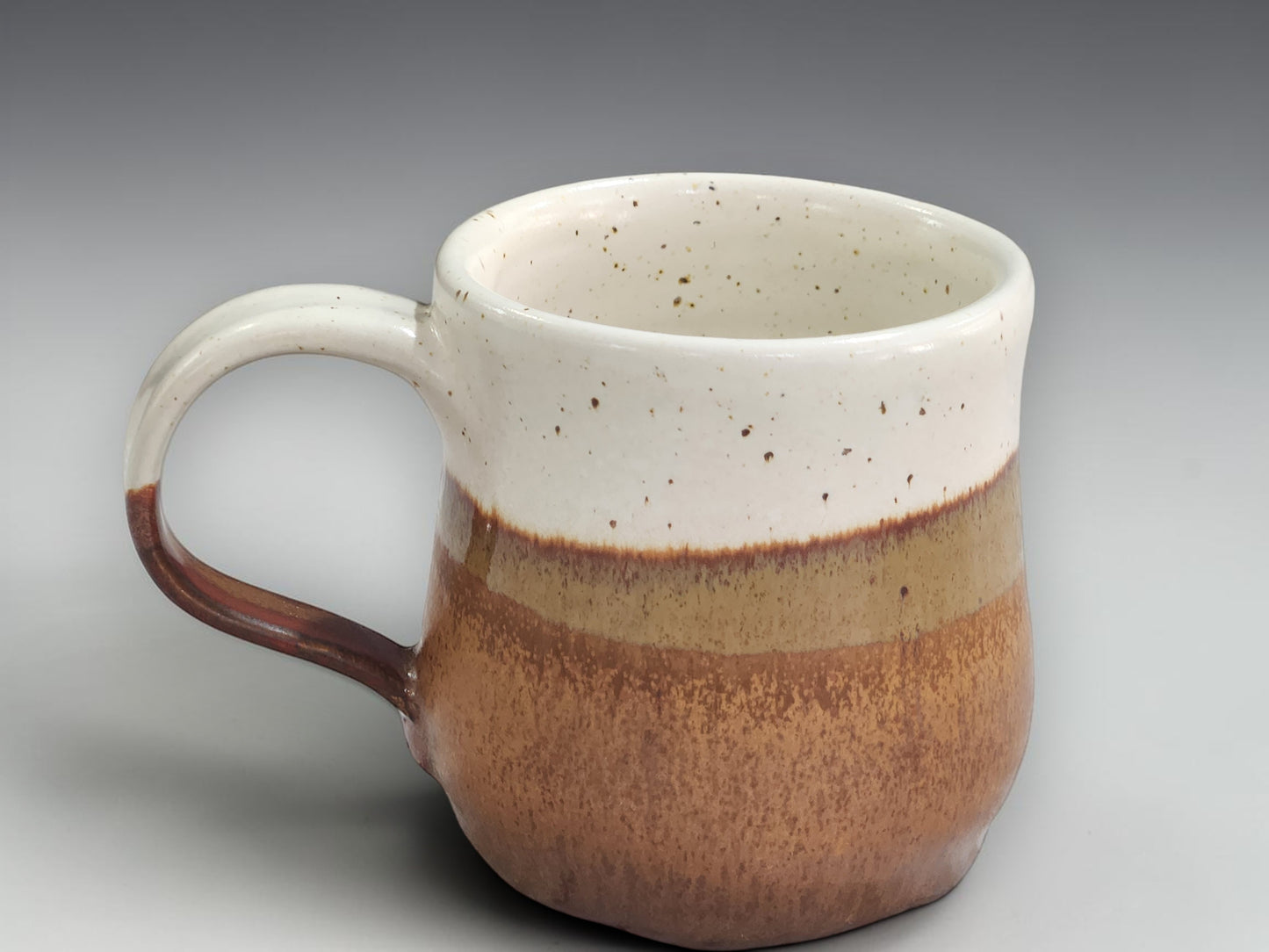 Handmade ceramic mug in cream and warm brown glaze