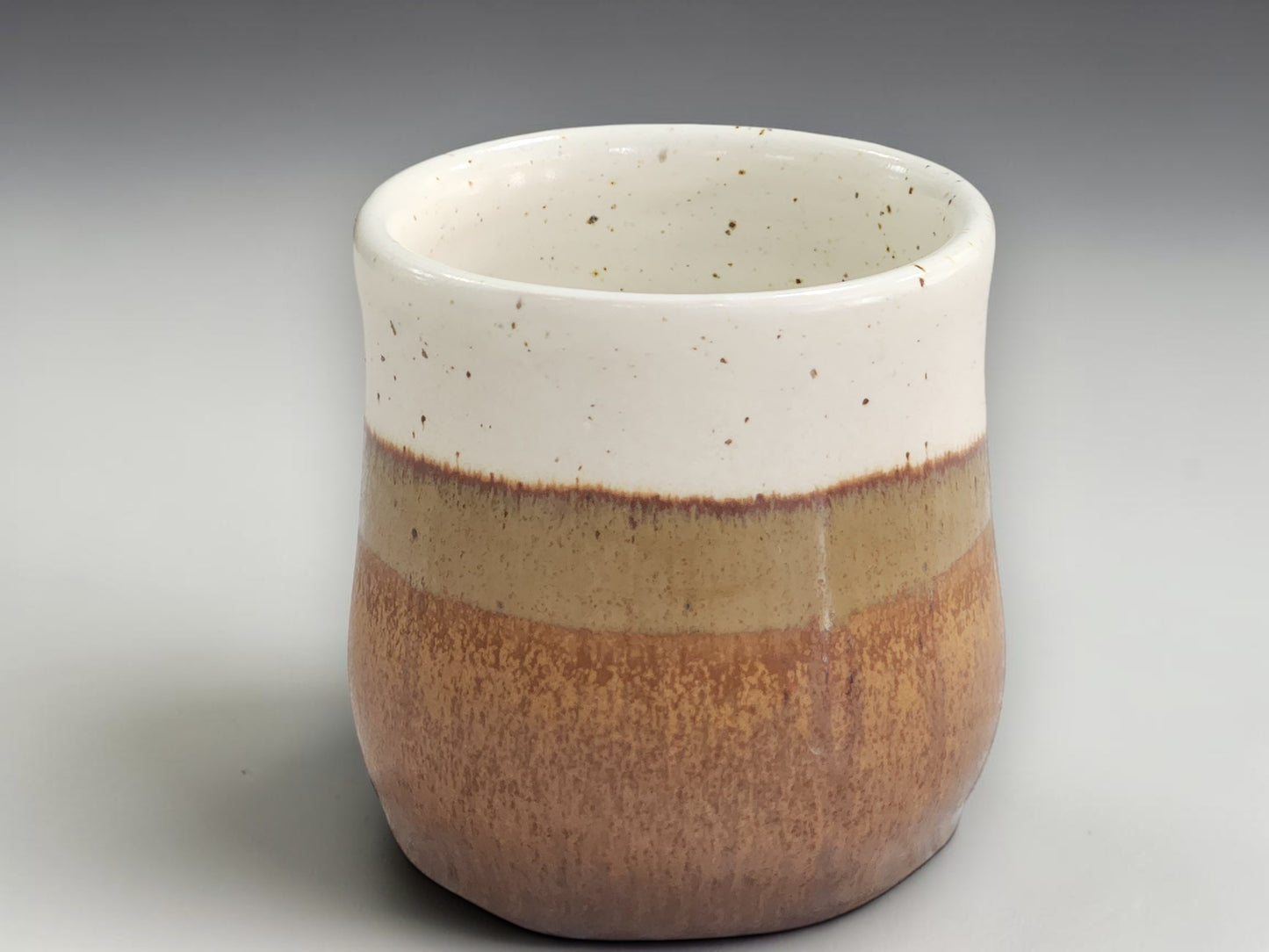 Handmade tea mug with cream upper glaze and brown base