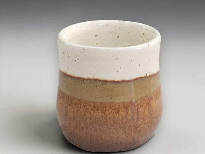 Handmade tea mug with cream upper glaze and brown base