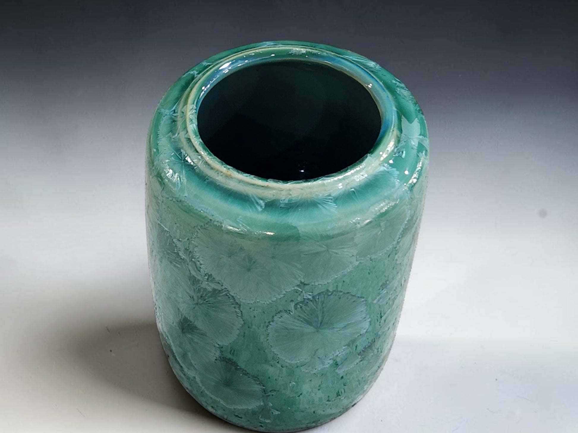 Wheel-thrown porcelain flower vase measuring 14 cm tall