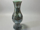 Large crystalline glaze vase showing floating crystal formations on dark green surface