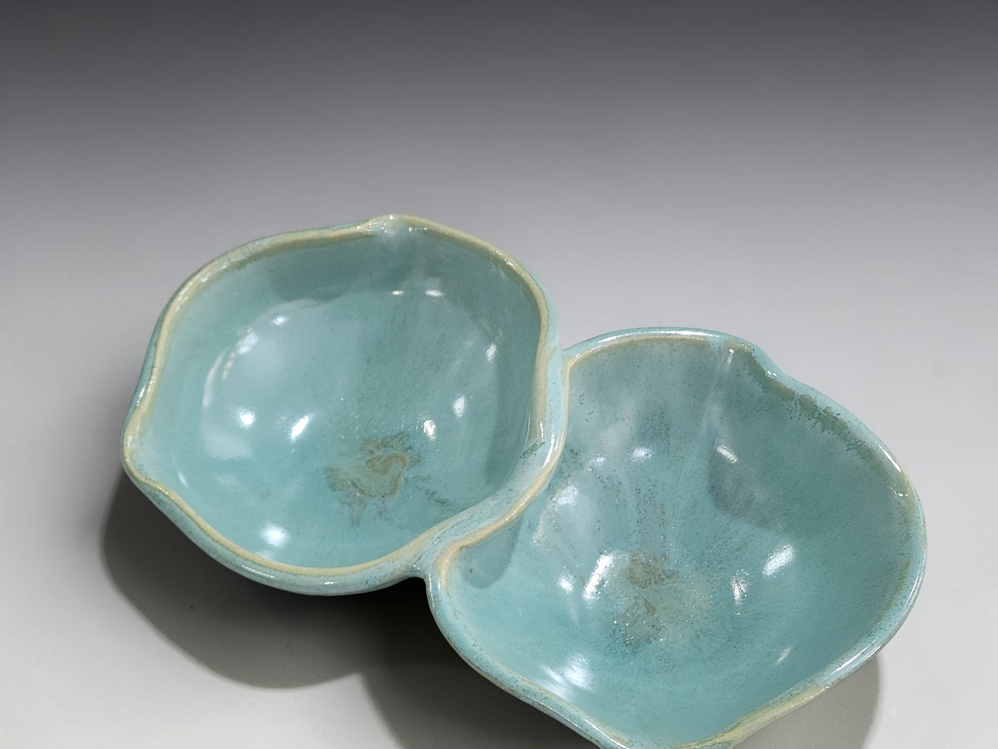 Handmade ceramic double snack bowl in soft aqua glaze
