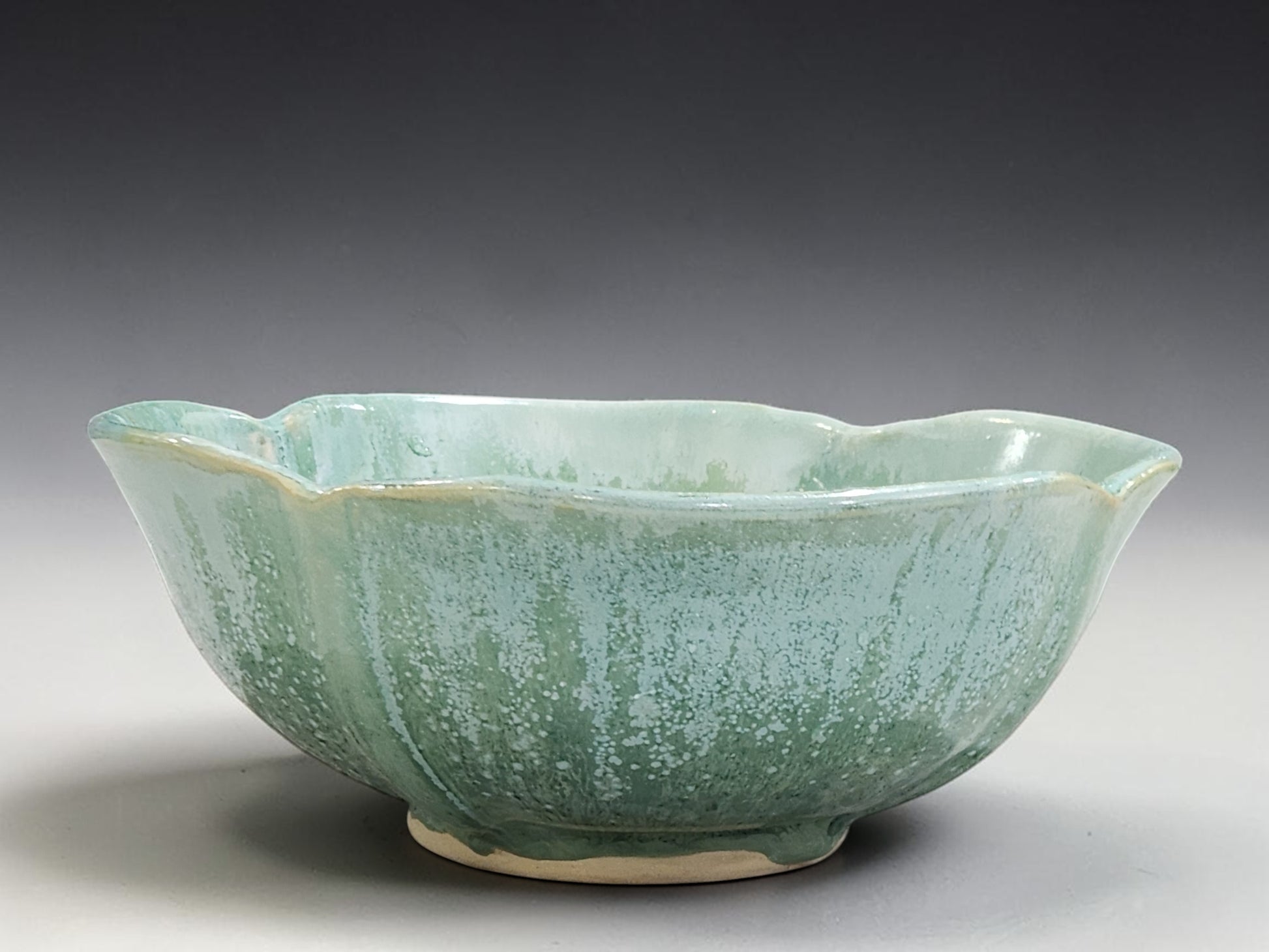 Handmade stoneware serving bowl with an organic wavy rim