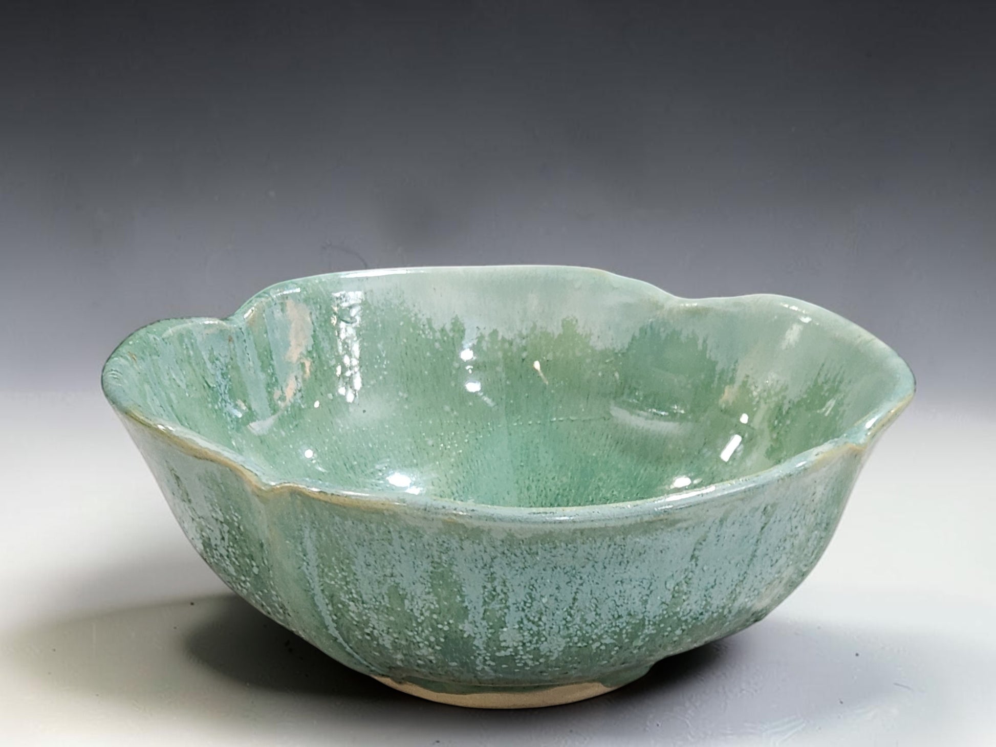 Australian handmade pottery serving bowl in glossy green glaze