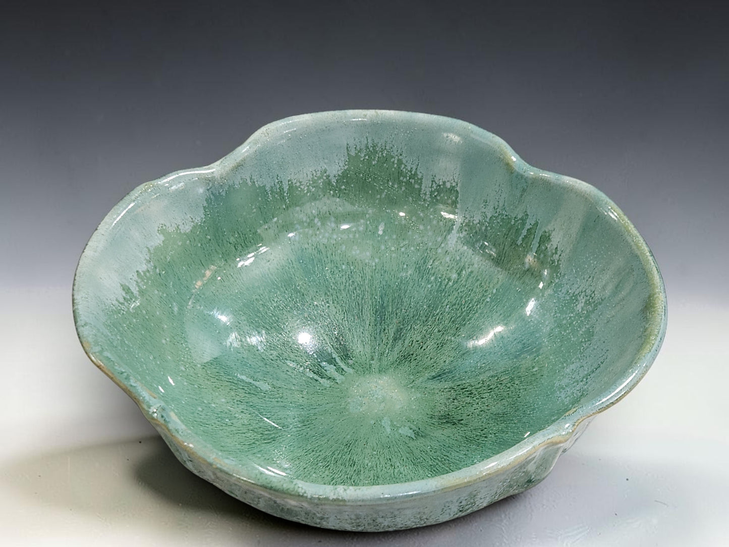 Decorative green fruit bowl with softly altered flower-shaped rim