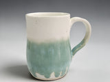 Handmade ceramic mug in cream and soft green glaze