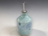 Artisan pottery oil bottle with glossy pale green glaze
