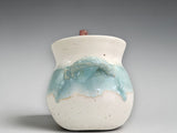 Small ceramic salt pig with soft aqua glaze and cream interior