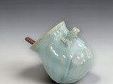 Green ceramic salt pig with angled opening for easy access
