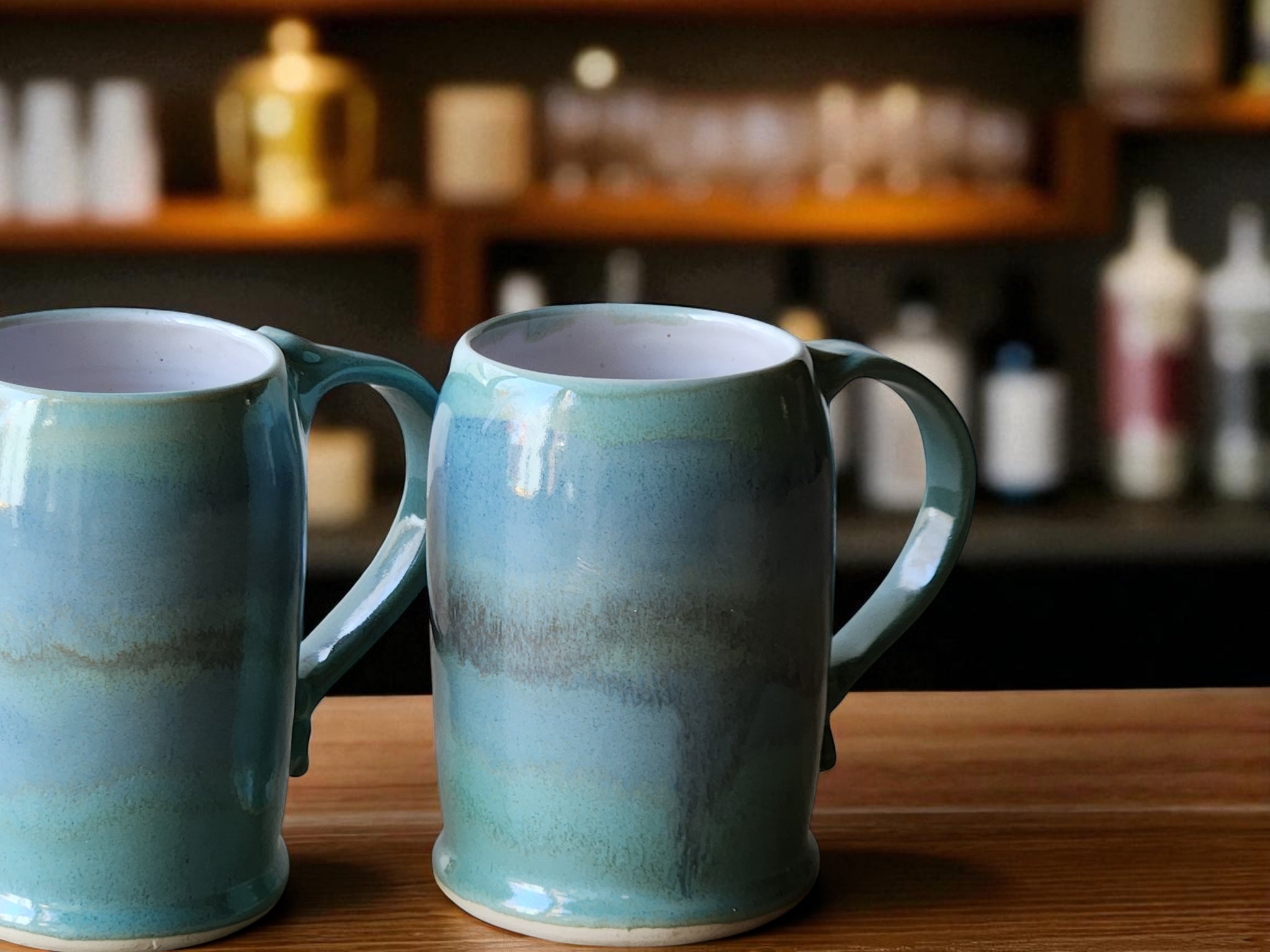Handmade ceramic beer stein with green and blue glaze